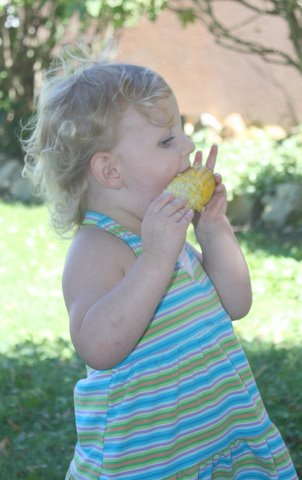 Photo of Molly Woodrich enjoying sweet corn!