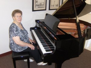 Photo of Donna Ihns and new baby grand piano.